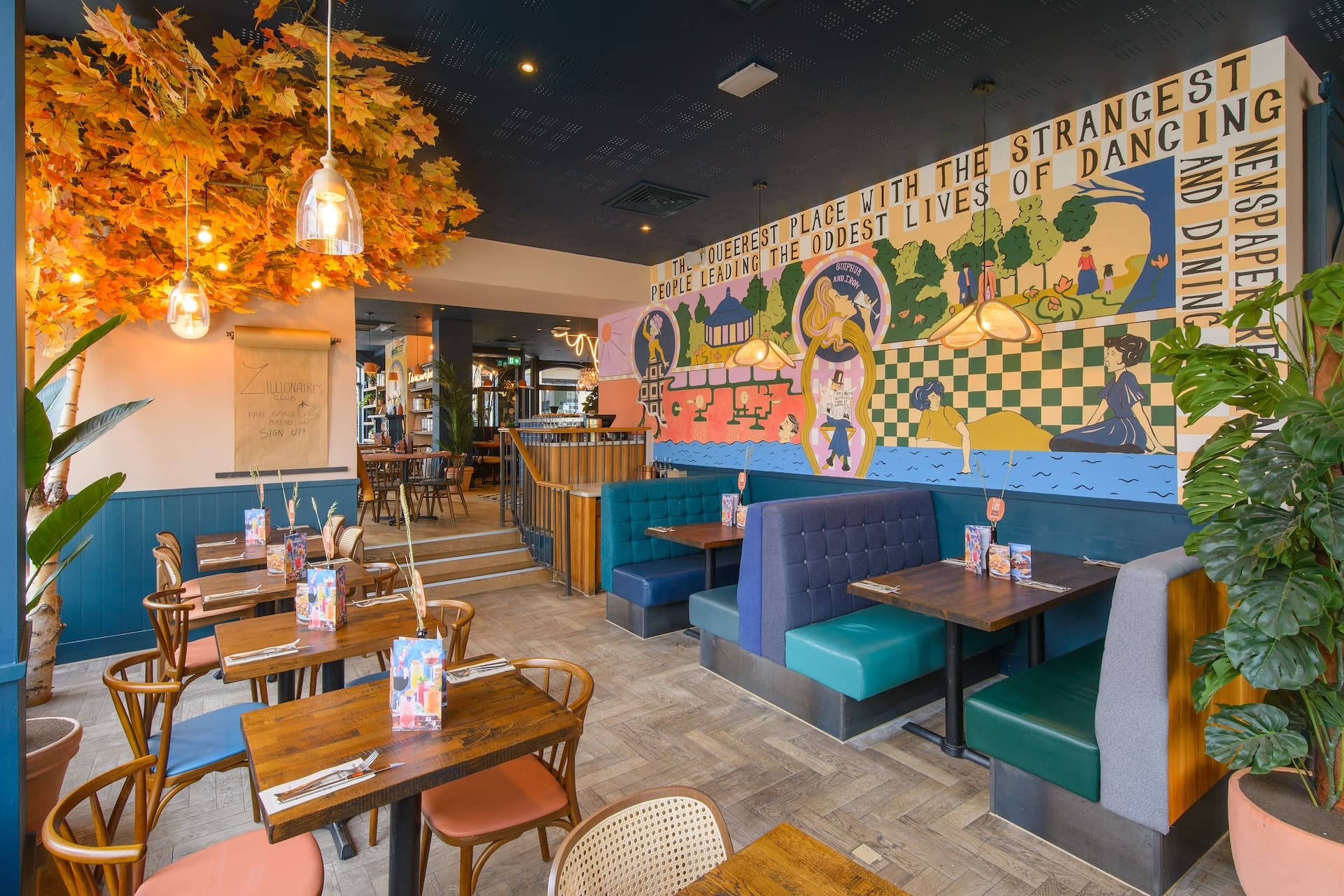 Zizzi Harrogate, vibrant dining with copper foliage ceiling decor.