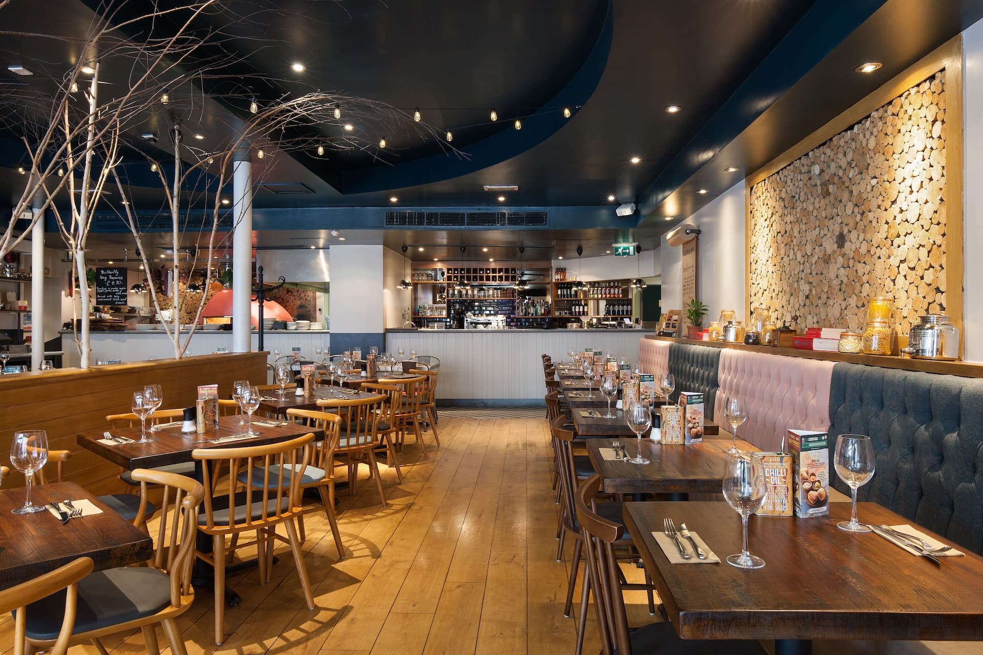 Stylish dining area at Zizzi Earl's Court with modern decor and natural accents.