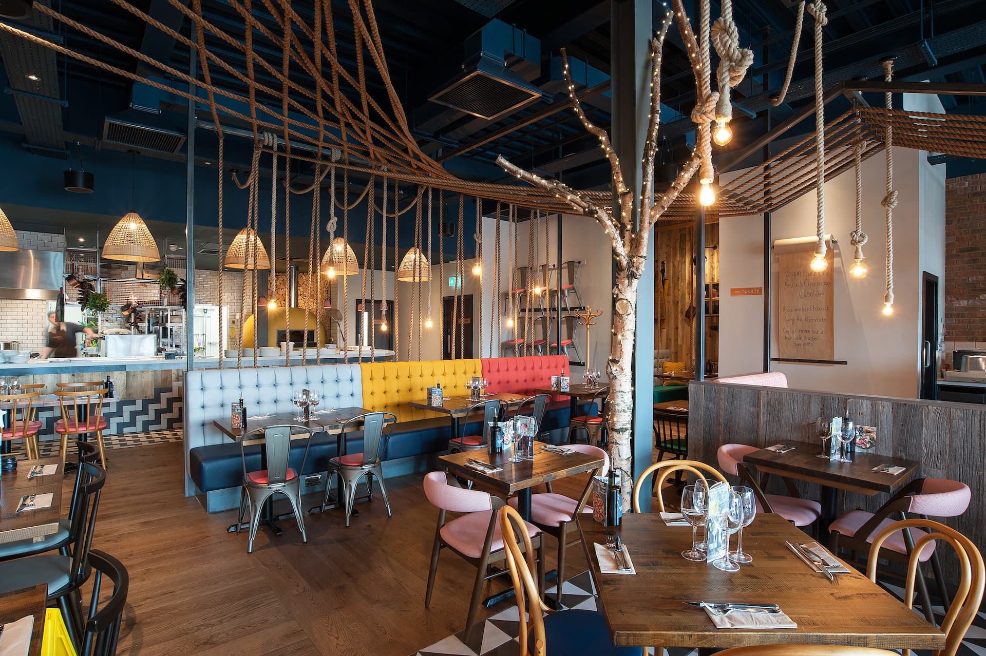 Warm, vibrant Zizzi Rushden Lakes, interior with rustic wood, rope art and modern accents.