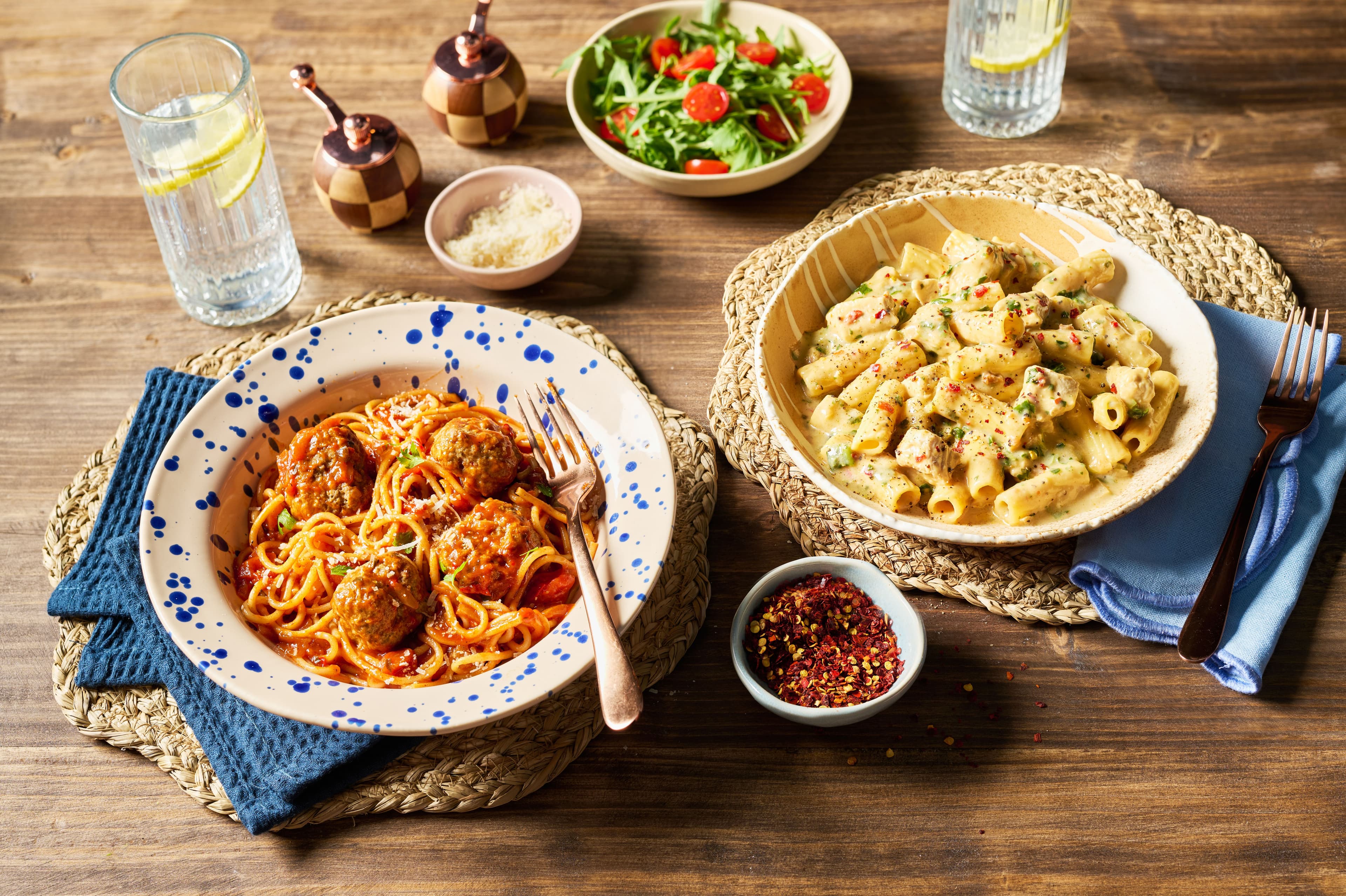 Spaghetti Meatball Arrabbiata and Spicy Chicken Rigatoni pasta on dining table.