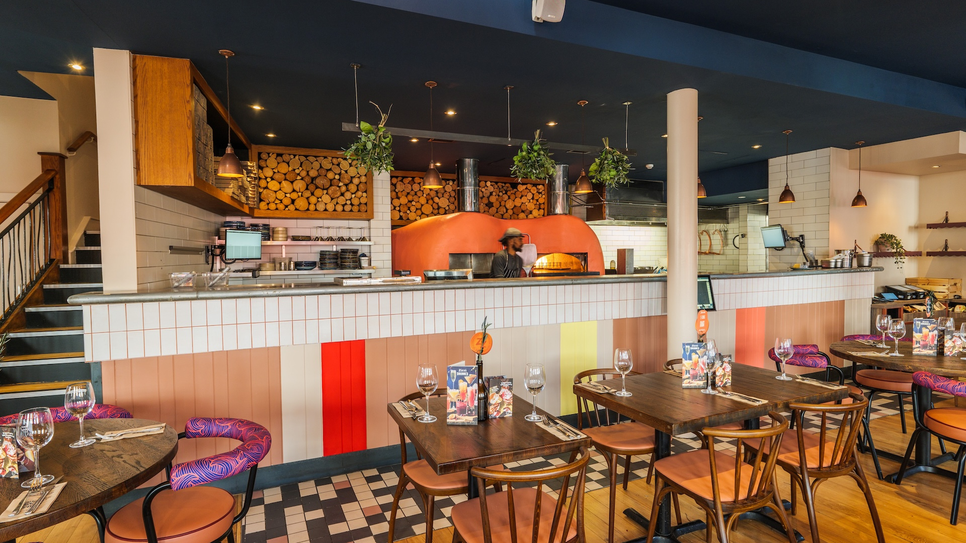 Zizzi Kingston inside seating with view of kitchen 