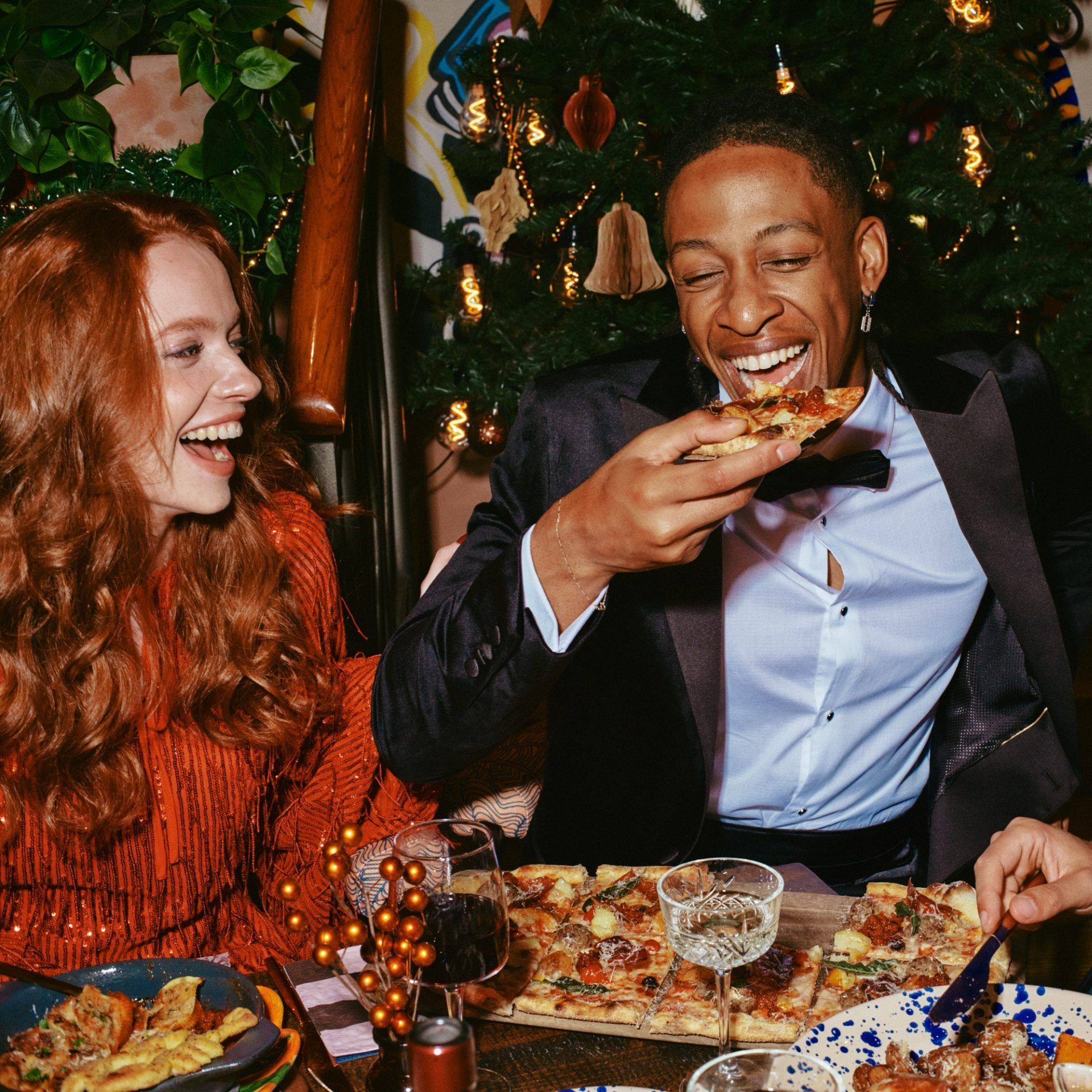 Friends sat at a table enjoying pizza 