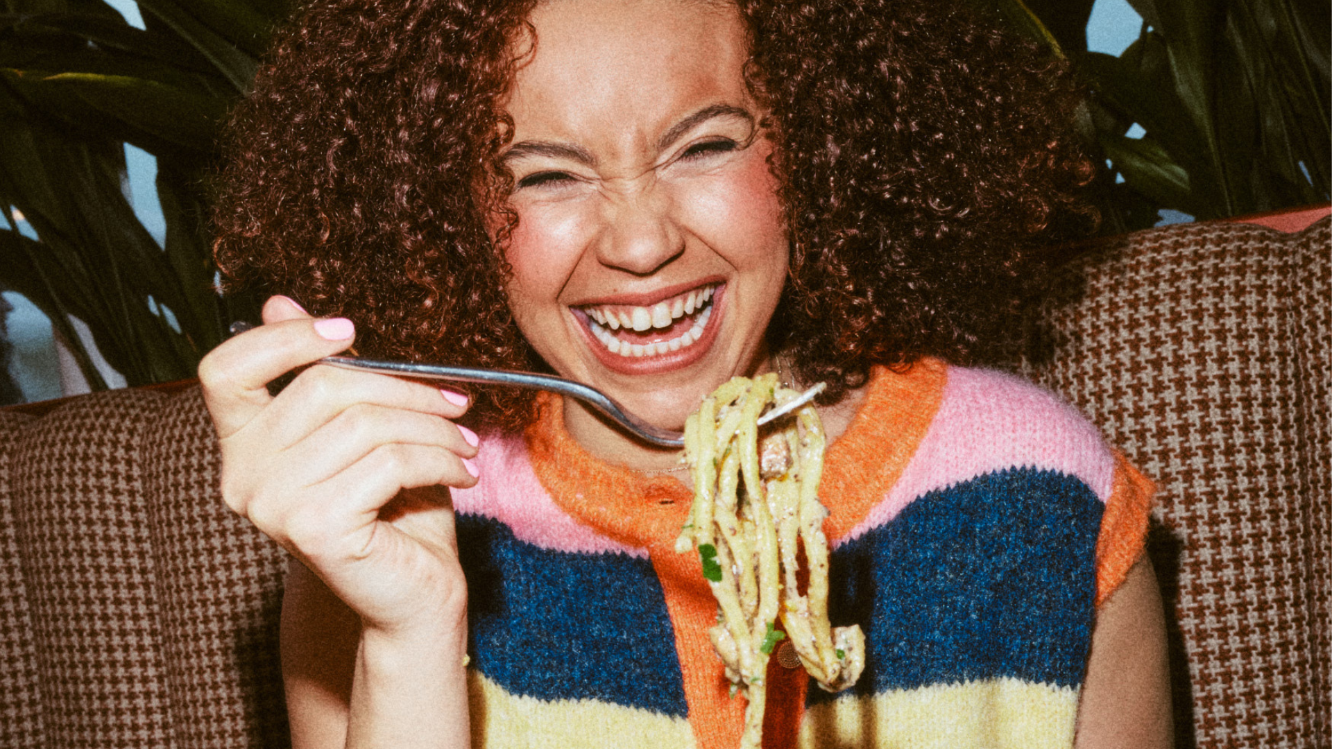 Woman twirling fresh Cacio e Pepe and smiling 