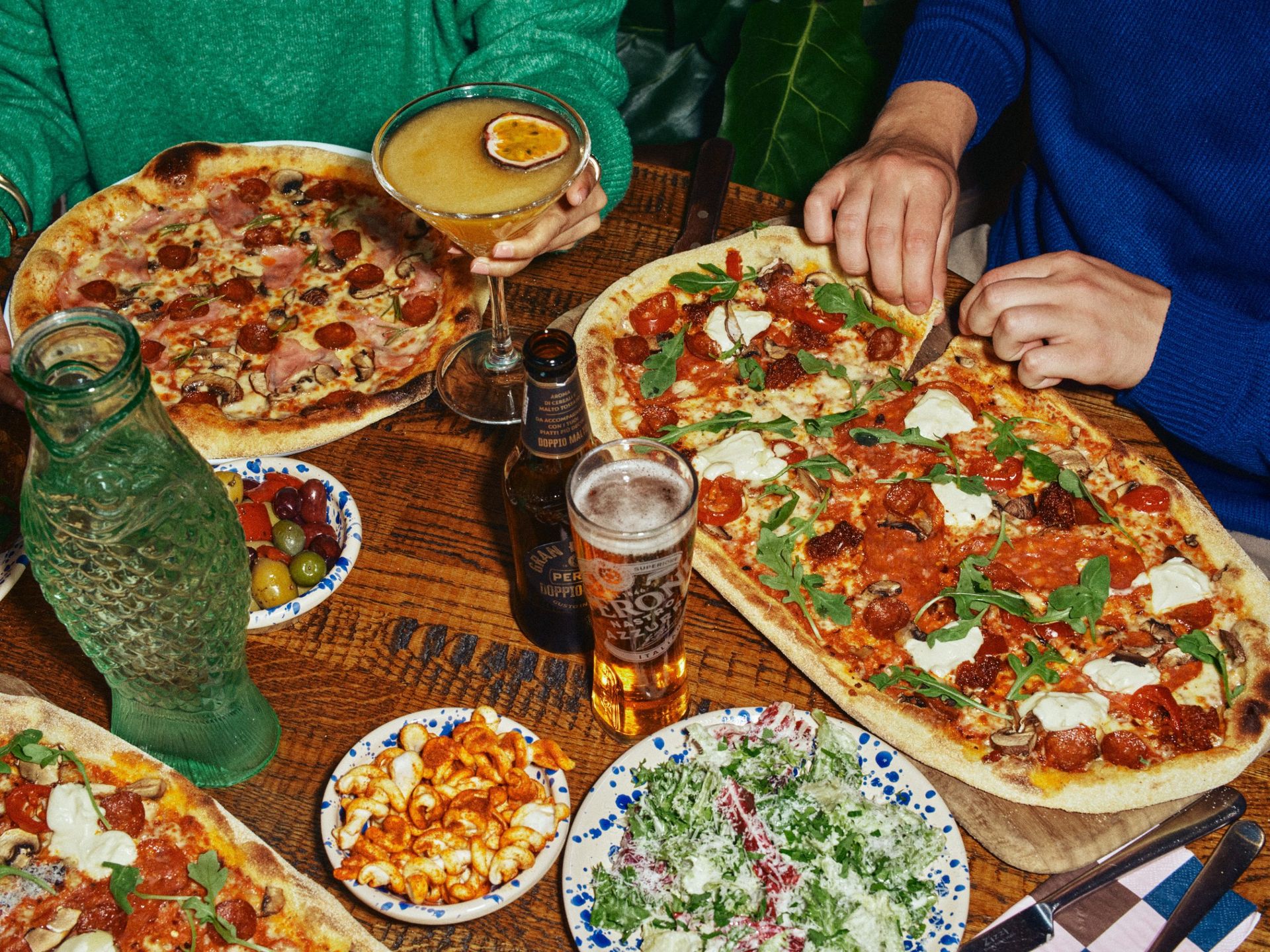 Feast shot of people eating pizzas