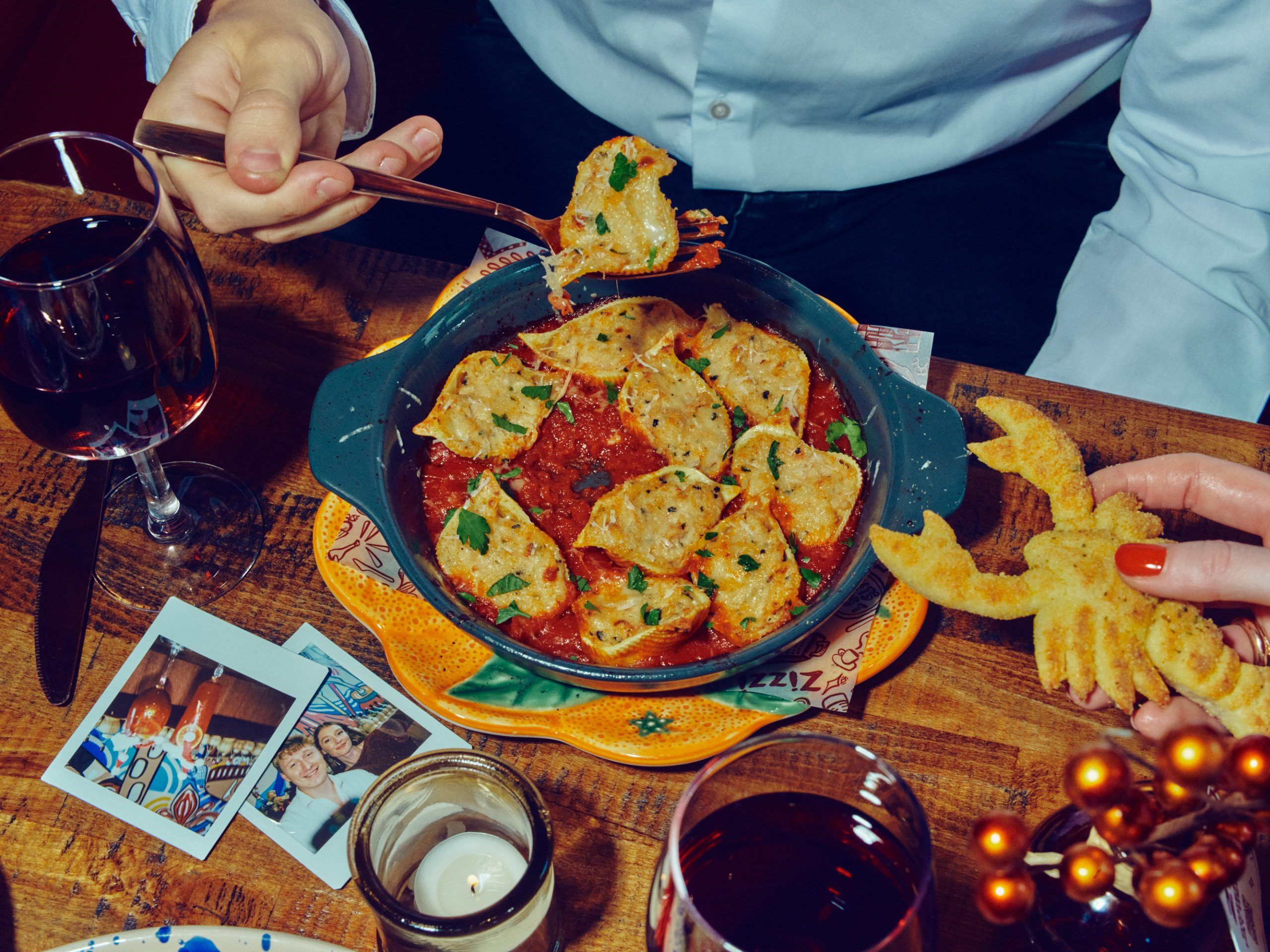 A photo of The Christmas Catch pasta. Oven-baked giant pasta shells filled with lobster, prawn, mascarpone, lemon & white wine. Pomodoro sauce. Garlic bread lobster. 