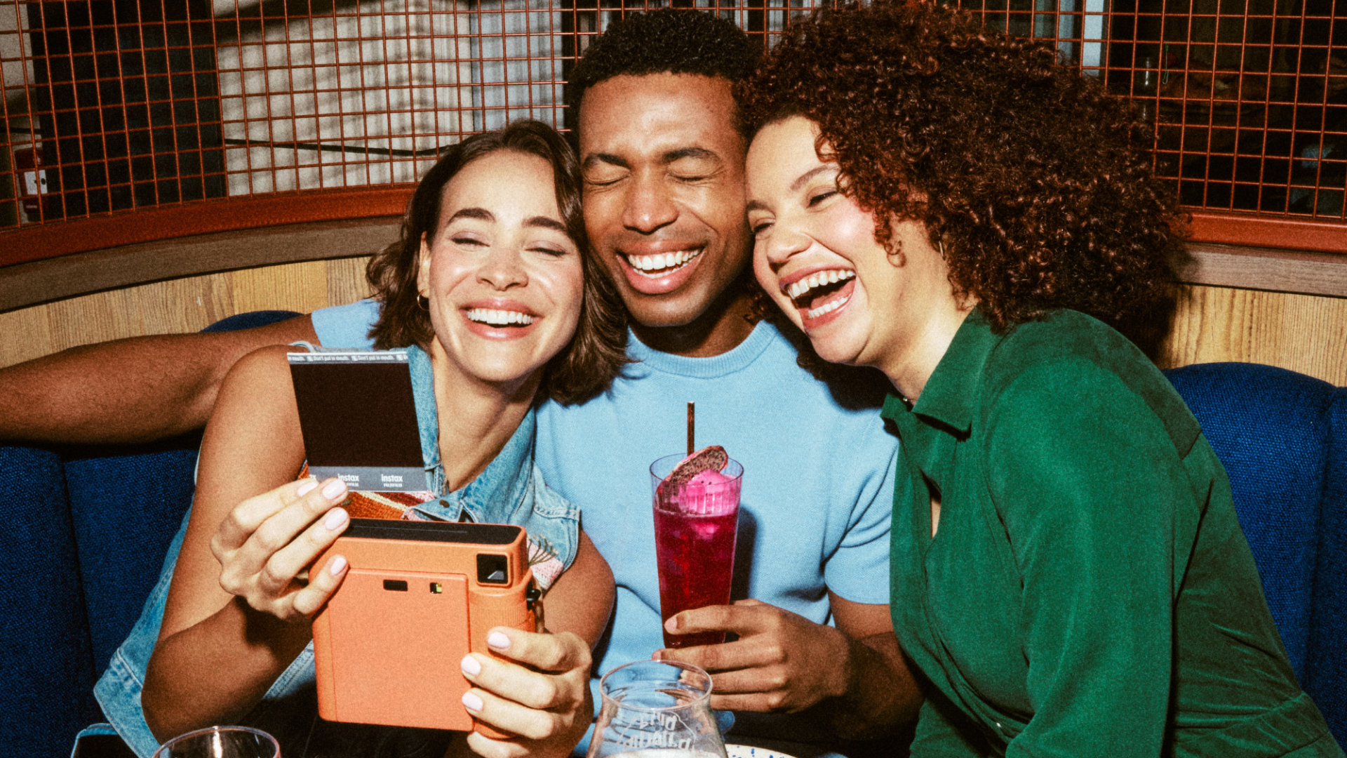 Group of friends taking a selfie and laughing with each other 